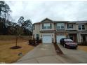 Charming two-story townhome boasts attached garages and a private driveway for convenient parking and easy access at 1022 Azimuth Dr, Durham, NC 27713