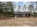 Wide exterior shot of the brick home and front yard surrounded by trees at 1066 Shuford Rd, Wake Forest, NC 27587
