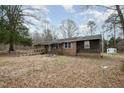 Exterior view of a brick home with a front porch and surrounding yard at 1066 Shuford Rd, Wake Forest, NC 27587