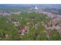 Secluded estate with a brick house nestled amidst dense trees and greenery with views of the adjacent water at 10726 Trego Trl, Raleigh, NC 27614