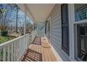 Side view of the covered front porch showing the painted gray siding and trimmed window at 1104 Mango Crest Dr, Knightdale, NC 27545