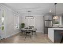 Open-concept dining area with stainless steel appliances and designer lighting at 1105 Massey St, Smithfield, NC 27577