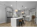 Bright kitchen with gray cabinets, stainless steel appliances, and an island with seating at 1105 Massey St, Smithfield, NC 27577