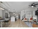 Open-concept living space featuring a modern kitchen, dining area, and cozy seating arrangement at 1105 Massey St, Smithfield, NC 27577