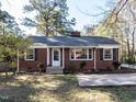 Inviting brick home with black shutters, manicured landscaping, and a welcoming front entrance at 1106 Northview St, Garner, NC 27529