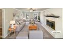 Bright living room featuring neutral tones, fireplace, and ample natural light, virtually staged at 120 Chattleton Ct, Durham, NC 27712