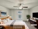 Bright main bedroom featuring a ceiling fan, large window and modern furnishings at 120 Chattleton Ct, Durham, NC 27712