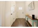 Bright hallway with hardwood floors and a decorative console table at 129 Edgefield Dr, Sanford, NC 27332