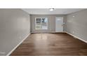 Empty living room featuring hardwood flooring and a front door view from the window at 13 Herndon Ct, Clayton, NC 27520