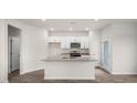 Bright kitchen with a large island, granite countertops and stainless steel appliances at 164 Starlight St, Sanford, NC 27330
