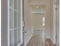 Inviting hallway with wood-look floors leads to an open living space and bedrooms at 165 Klamath Dr, Garner, NC 27529