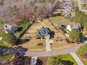 Expansive aerial view of a two-story home with a large, well-maintained yard with mature trees and landscaping at 1726 River Club Way, Franklinton, NC 27525
