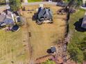 Aerial view of home featuring a backyard patio area, full perimeter fence and a storage shed at 1726 River Club Way, Franklinton, NC 27525
