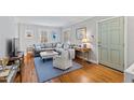 Bright living room features hardwood floors, a cozy gray sofa, and tasteful decor at 1817 Rankin St, Raleigh, NC 27604