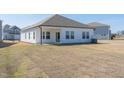 Expansive backyard featuring a covered patio, freshly seeded lawn, and ample space for outdoor activities at 185 White Birch Ln, Angier, NC 27501