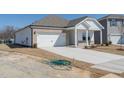 Beautiful home showcasing brick and siding exterior, attached two-car garage, and landscaping ready for personalization at 185 White Birch Ln, Angier, NC 27501