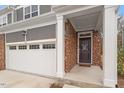 Close-up of the townhome's entrance, showcasing the brickwork and an inviting front porch at 193 Millennium Dr, Pittsboro, NC 27312