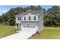 Charming two-story home with a well-manicured lawn and a spacious two car garage at 20 Diamond Creek Dr, Zebulon, NC 27597