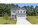 Charming two-story home with a well-manicured lawn and a spacious two car garage at 20 Diamond Creek Dr, Zebulon, NC 27597