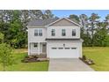 Charming two-story home with landscaped yard and an attached two-car garage at 20 Diamond Creek Dr, Zebulon, NC 27597