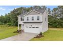 Charming two-story home with landscaped yard and an attached two-car garage at 20 Diamond Creek Dr, Zebulon, NC 27597