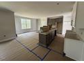 Bright kitchen featuring a central island, stylish cabinets, and plenty of natural light at 20 Diamond Creek Dr, Zebulon, NC 27597