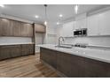 Modern kitchen with stainless steel appliances, a large island and stylish pendant lighting at 20 Diamond Creek Dr, Zebulon, NC 27597