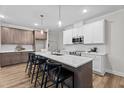 Spacious kitchen featuring a large center island, stylish pendant lighting, and modern appliances at 20 Diamond Creek Dr, Zebulon, NC 27597