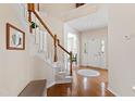 Inviting entryway featuring hardwood floors, staircase, and abundant natural light at 2016 Terri Creek Dr, Fuquay Varina, NC 27526