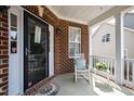 Cozy front porch with white rocking chair and welcome mat for a charming entrance at 2016 Terri Creek Dr, Fuquay Varina, NC 27526