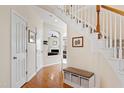 Bright hallway with hardwood floors and views into other living spaces at 2016 Terri Creek Dr, Fuquay Varina, NC 27526