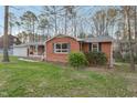 Low angle view of a red brick home with a manicured lawn at 209 High House Rd, Cary, NC 27513