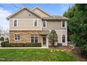 Charming two-story home with a combination of stone and siding, complemented by lush landscaping at 2302 Wispy Green Ln, Raleigh, NC 27614