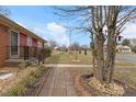 A home with stone walkway, established yard, and mature trees in a quiet neighborhood at 2503 Mckinney St, Burlington, NC 27217