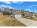 Well-maintained home with a two-car garage, long driveway, and spacious yard with a manicured lawn at 2728 Spring Valley Dr, Creedmoor, NC 27522