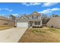 Two-story home with a two-car garage, tidy landscaping, and a welcoming front porch at 2728 Spring Valley Dr, Creedmoor, NC 27522