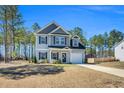 Charming two-story home with attached garage, long driveway, and well-maintained landscaping at 286 Beacon Hill Rd, Lillington, NC 27546