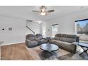 Comfortable living room featuring modern furnishings, a ceiling fan, and lots of natural light at 286 Beacon Hill Rd, Lillington, NC 27546