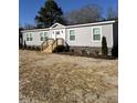 Beautiful single story home boasts gray siding, white trim, and a welcoming entryway at 321 Duke Memorial Road, Louisburg, NC 27549