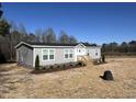 Single story home features gray siding, white trim, and a well-kept lawn at 321 Duke Memorial Road, Louisburg, NC 27549