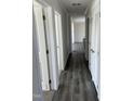 Hallway showcases modern dark flooring, white trim, and multiple doors at 321 Duke Memorial Road, Louisburg, NC 27549