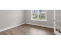Bright bedroom with wood floors, base molding and a large window overlooking the neighborhood at 329 Umstead St, Sanford, NC 27330