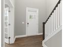 Inviting foyer with hardwood floors, white trim, and a staircase leading to the upper level, offering a warm welcome at 329 Umstead St, Sanford, NC 27330