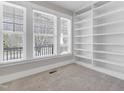 Light filled bedroom featuring neutral paint, carpeted floors and built in shelving at 375 N Serenity Hill Cir, Chapel Hill, NC 27516