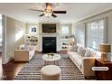 Staged living room showcasing a fireplace with built-in shelving, plush seating, and a striped rug at 375 N Serenity Hill Cir, Chapel Hill, NC 27516