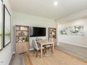 Bright dining room with neutral walls, hardwood floors, and a table set for four at 3837 Rosebush Dr, Zebulon, NC 27597