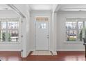 Bright foyer with hardwood floors, a front door, and windows offering ample natural light at 4108 Overcup Oak Ln, Cary, NC 27519
