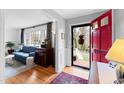View from open front door to living room with hardwood floors and stylish decor at 4209 Converse Dr, Raleigh, NC 27609