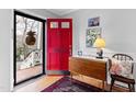Bright foyer with hardwood floors and a vibrant red door creates a warm welcome at 4209 Converse Dr, Raleigh, NC 27609