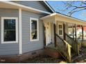 Side view of a gray two-story house featuring white trim, large windows, and brick foundation at 425 S Mercer St, Rocky Mount, NC 27801